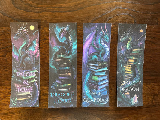 Four dragon-themed bookmarks on a wooden surface